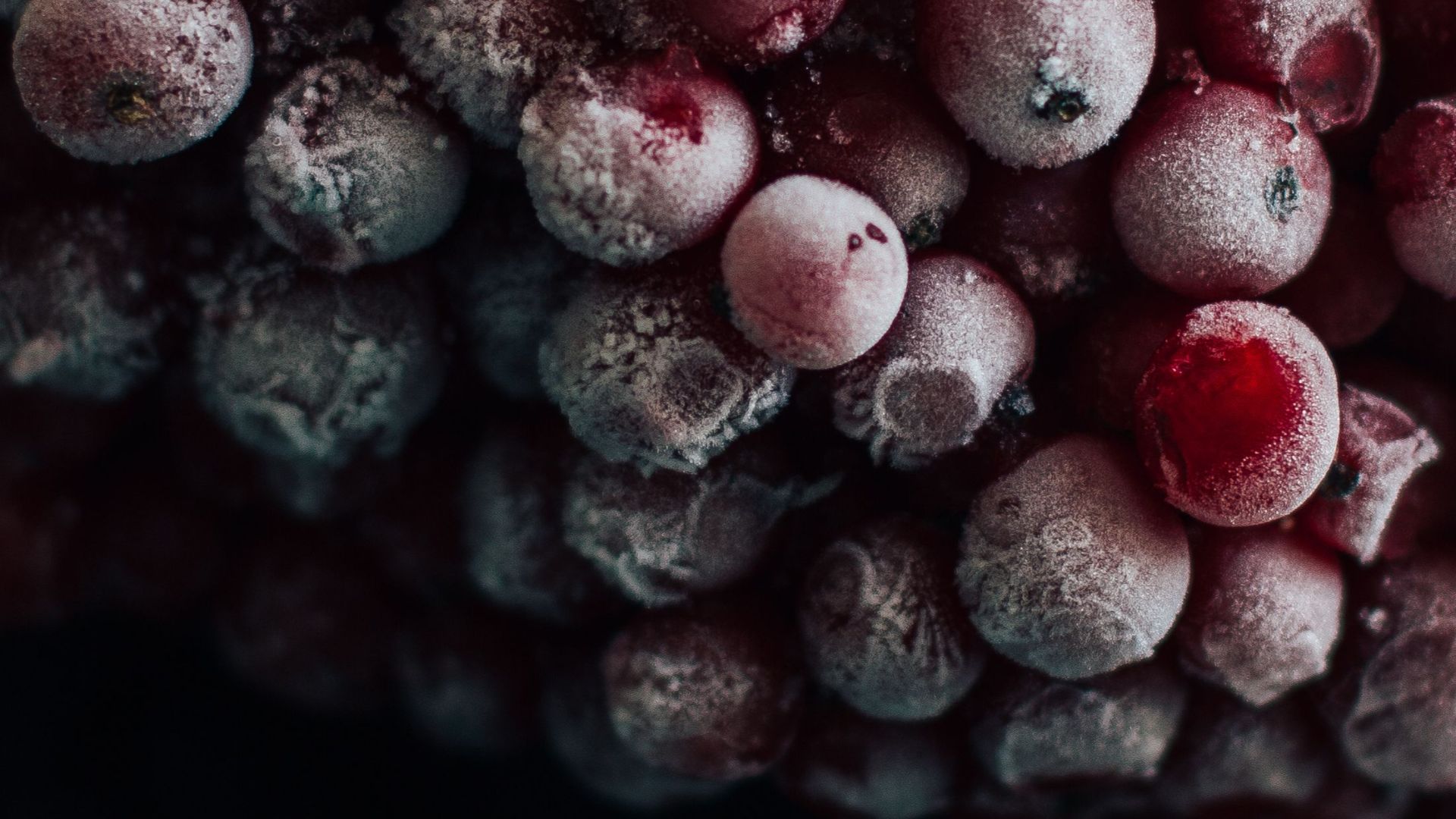Frosted red berries piled high, showcasing freshness and natural vibrancy.