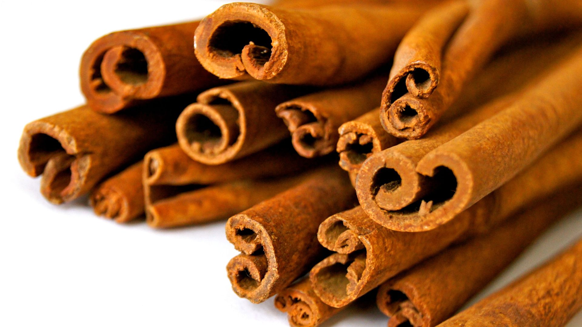Aromatic cinnamon sticks displayed in a close-up view, capturing the texture and rich brown color.