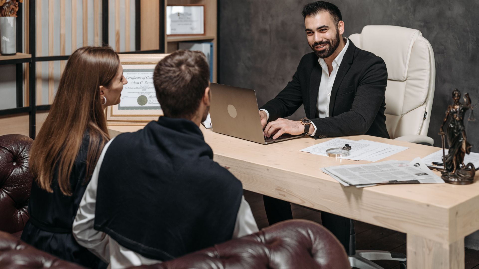 A professional meeting with a lawyer consulting clients in an upscale office environment.