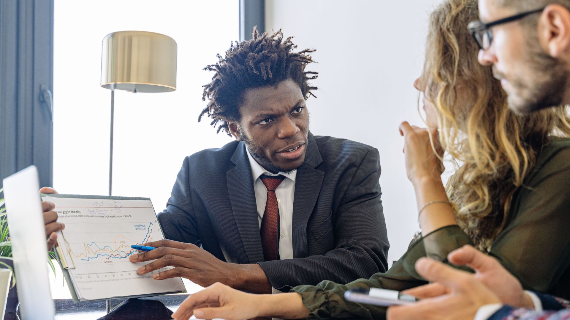 Business professionals discussing financial data during a collaborative meeting.