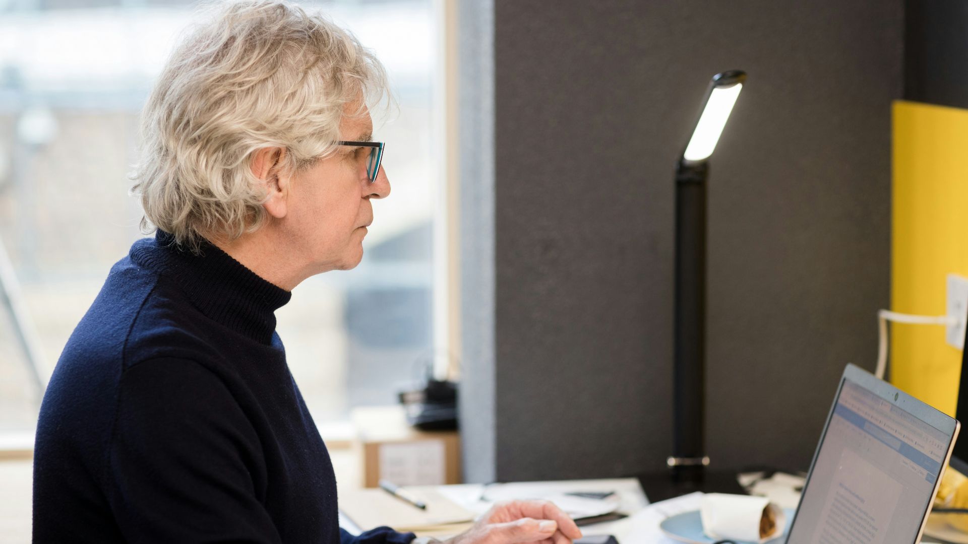 a woman sitting in front of a laptop computer