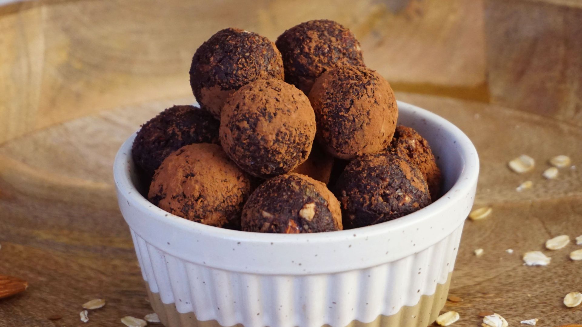 A bowl of homemade vegan chocolate energy bites made with natural ingredients for a guilt-free snack.
