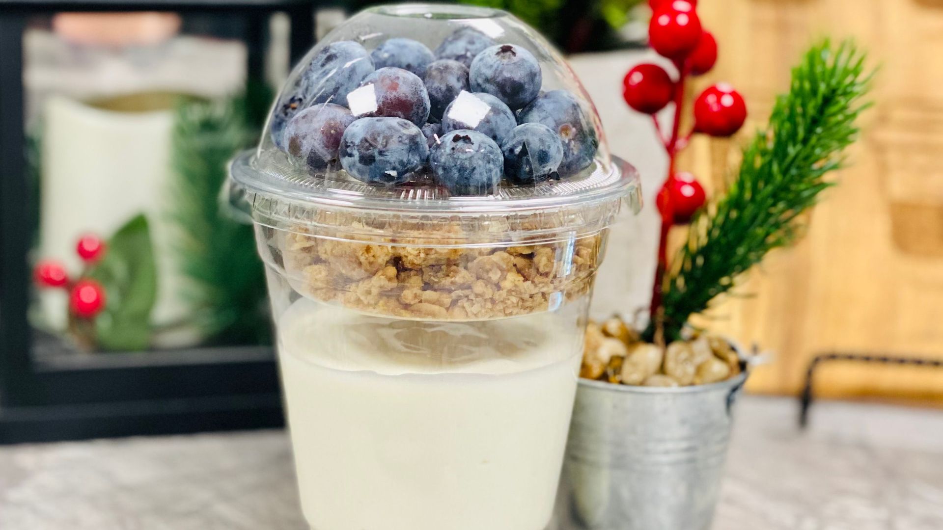 A delicious yogurt parfait topped with blueberries and granola, perfect for a healthy snack or breakfast.