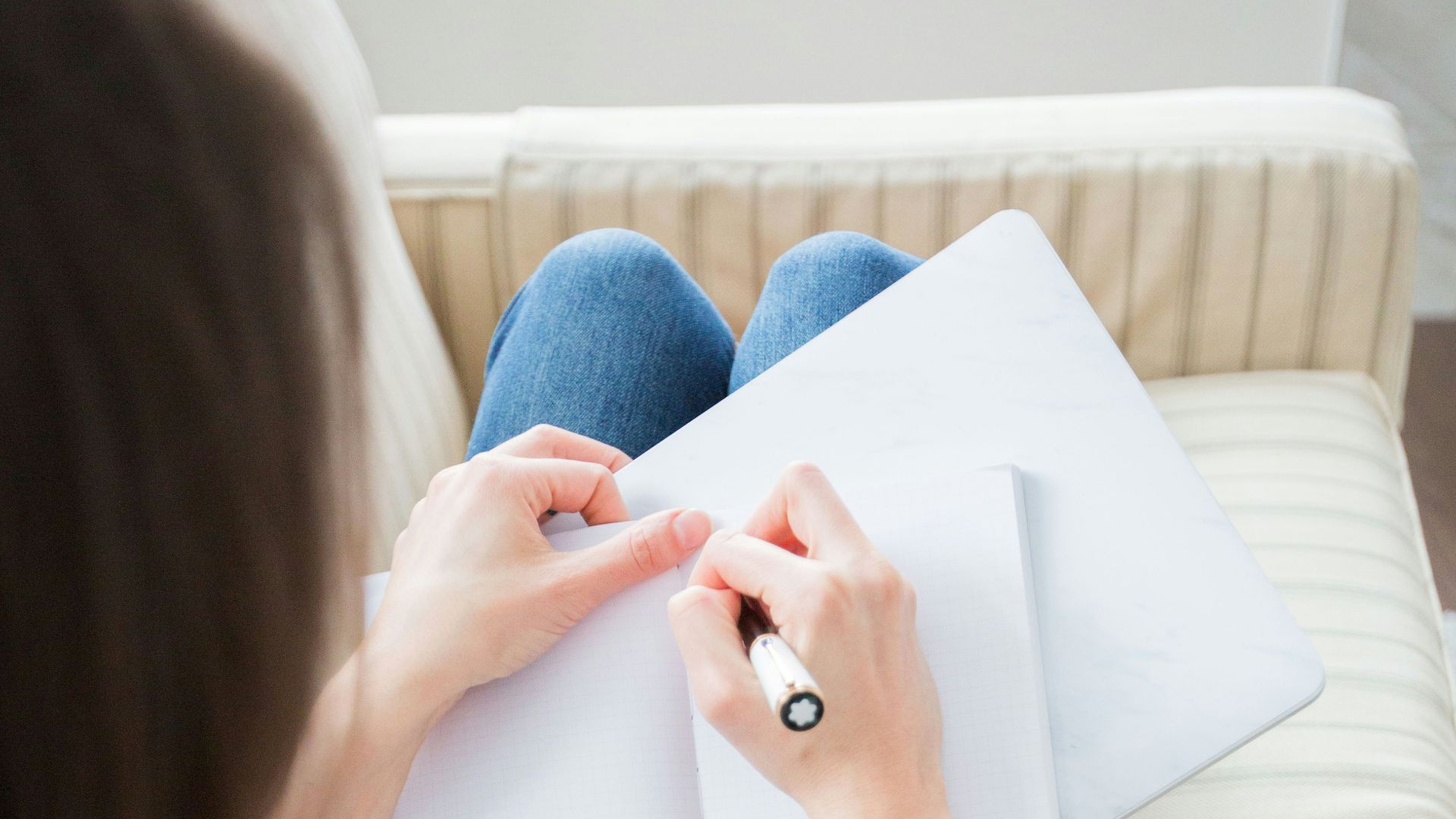 woman writing on white paper
