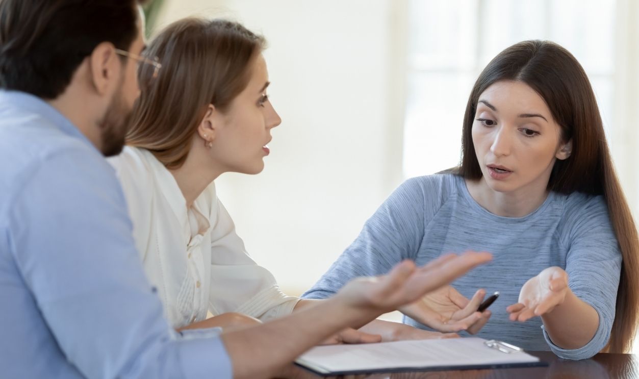 We shall complain to your superiors. Angry worried annoyed young family couple customers clients dissatisfied with bad unfair contract conditions, arguing with agent consultant lawyer prove their case