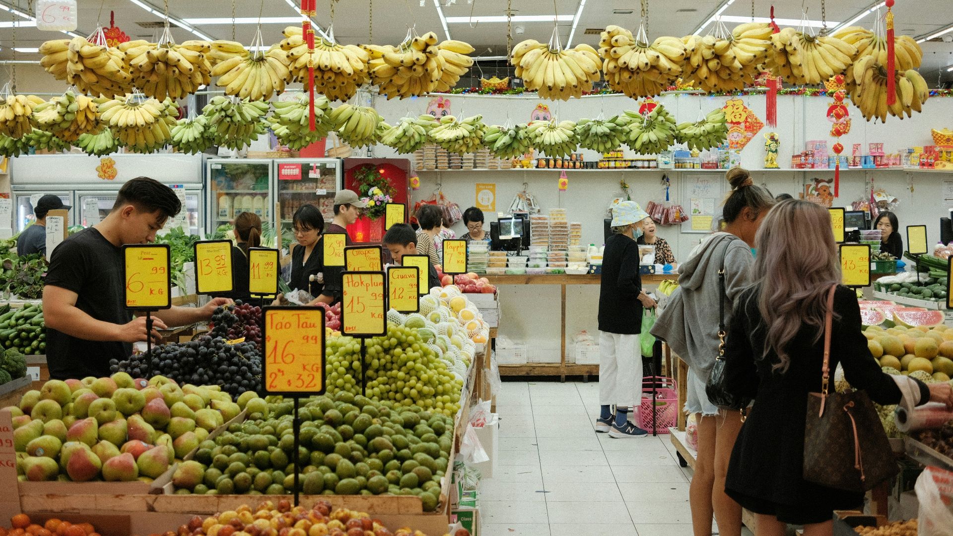 People shop for produce in a vibrant market