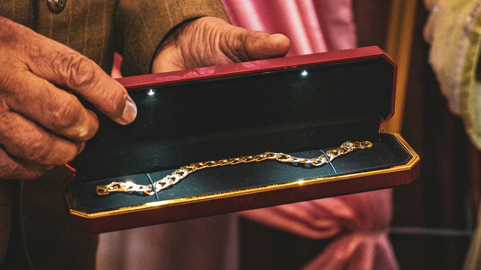 A man holding a box with a chain on it