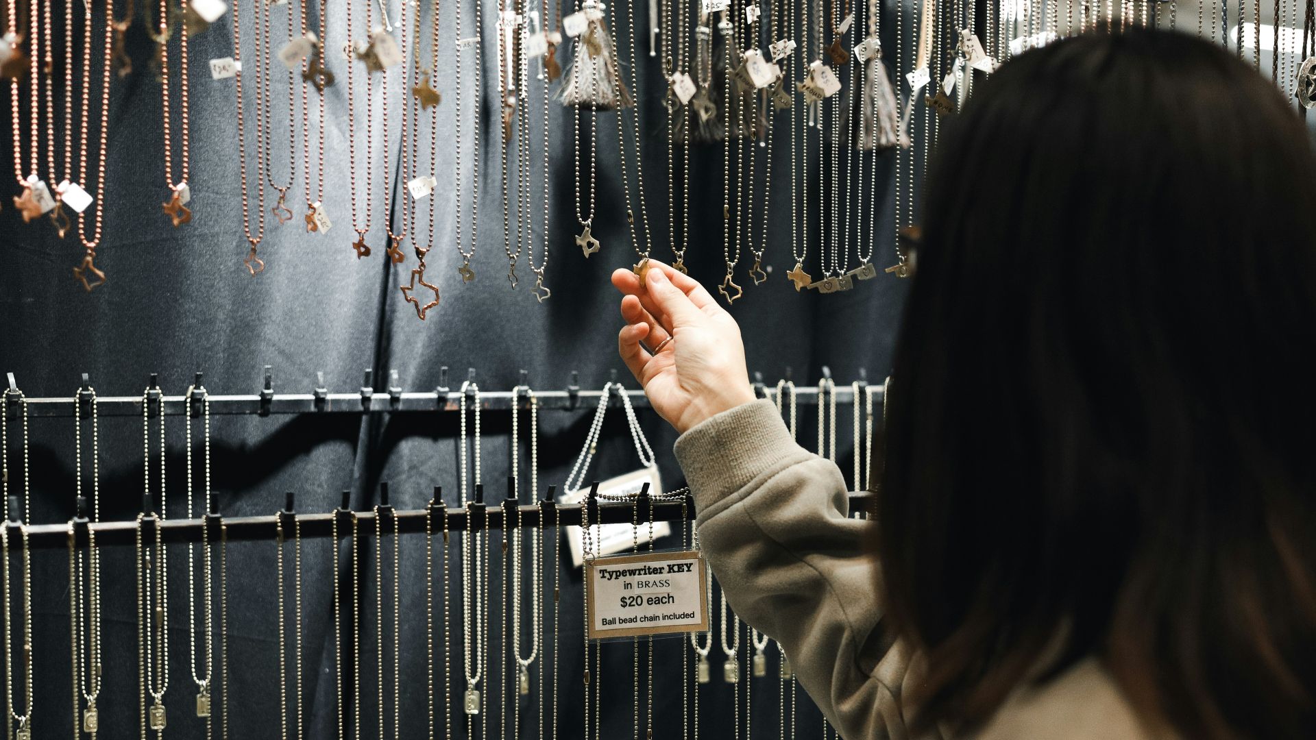 A woman looking at a display of jewelry