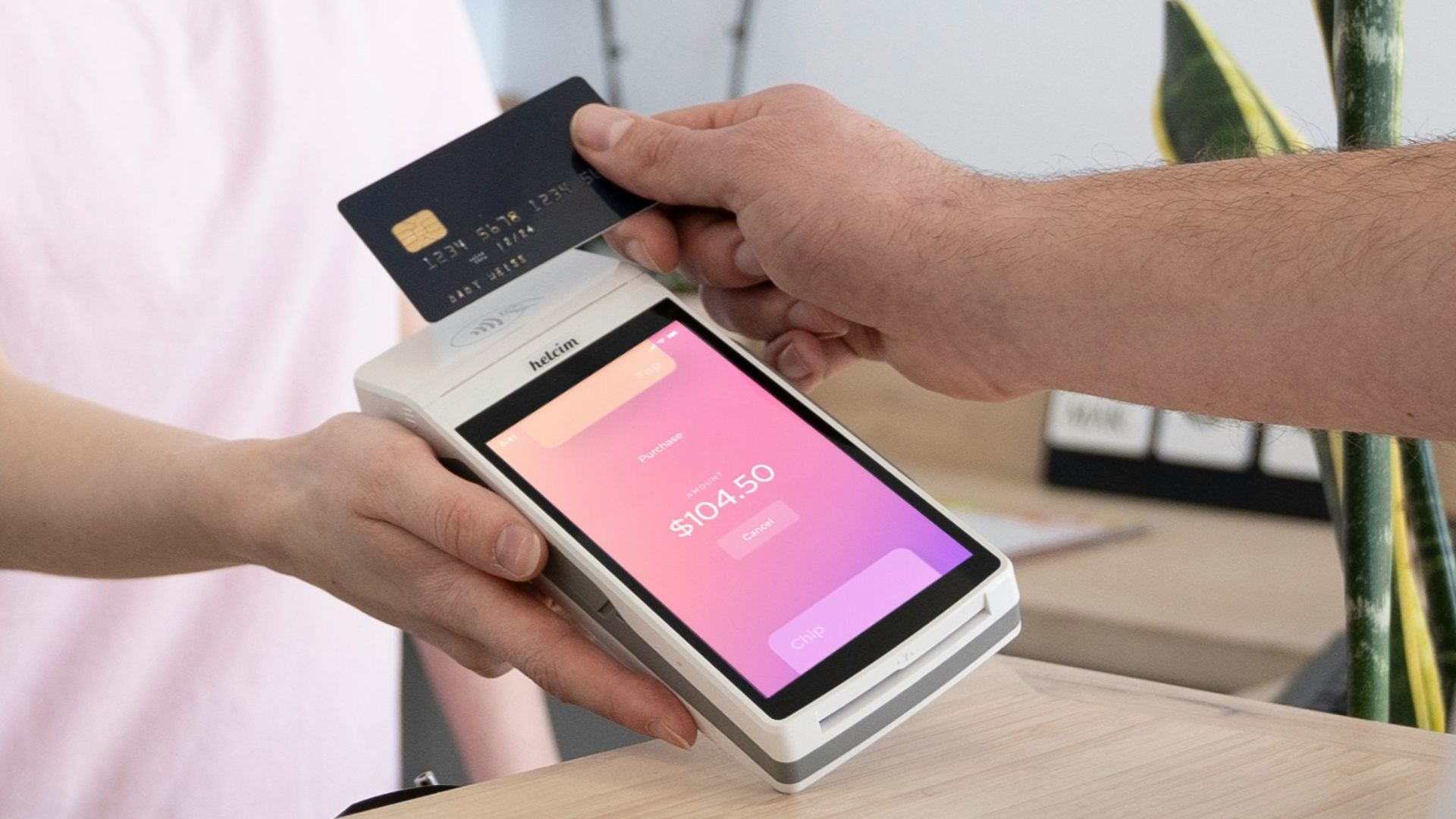 a woman is handing a card to a man