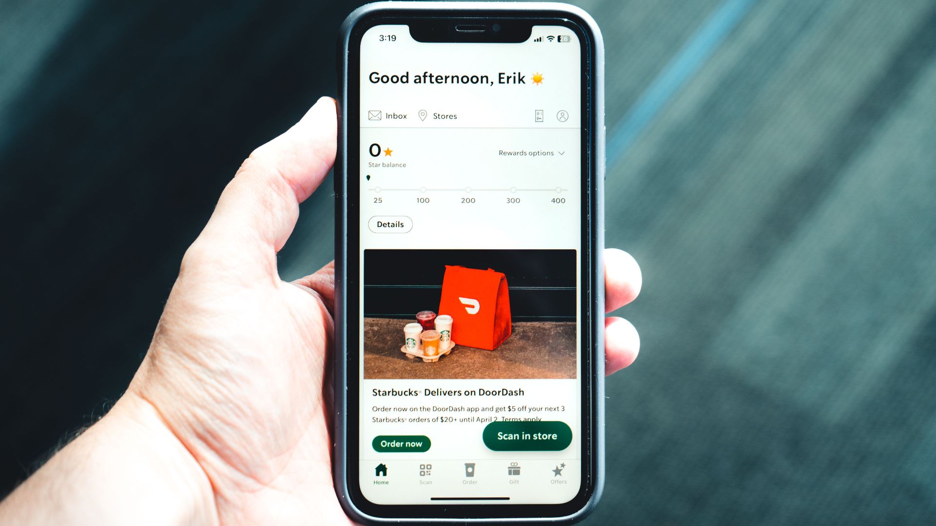 Close-up of a smartphone with a delivery app interface in a person's hand, emphasizing modern e-commerce.
