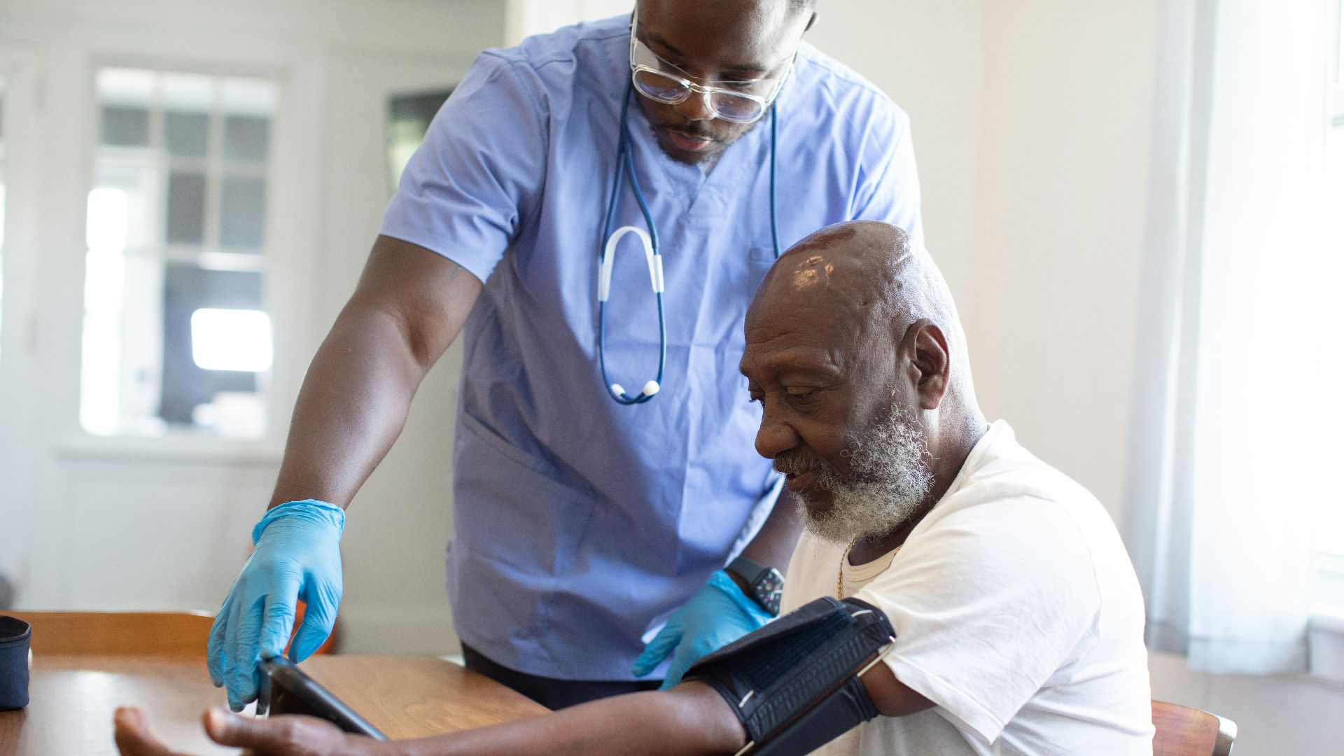 a man showing a man something on the tablet