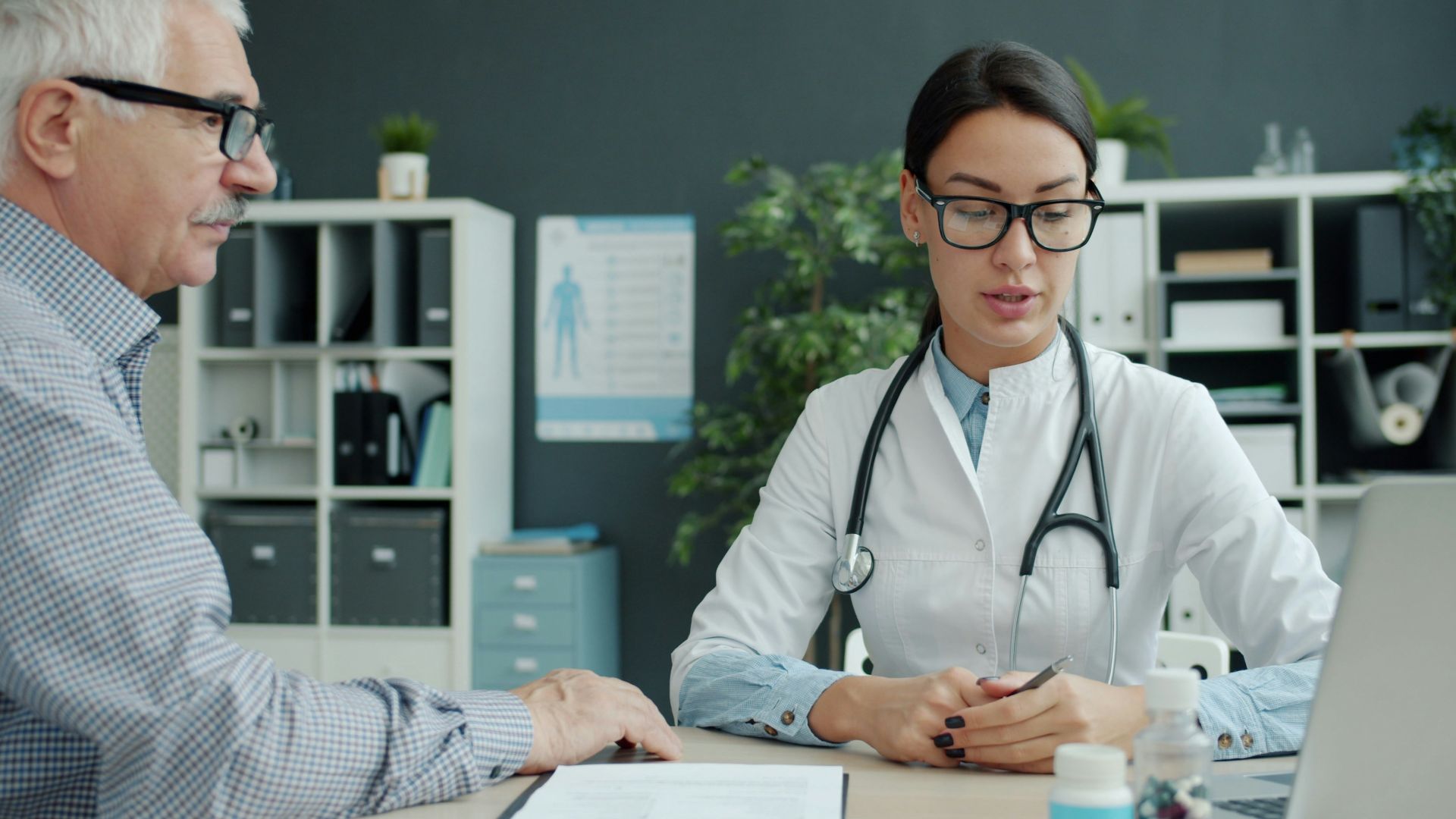Doctor consulting with an elderly patient in an office