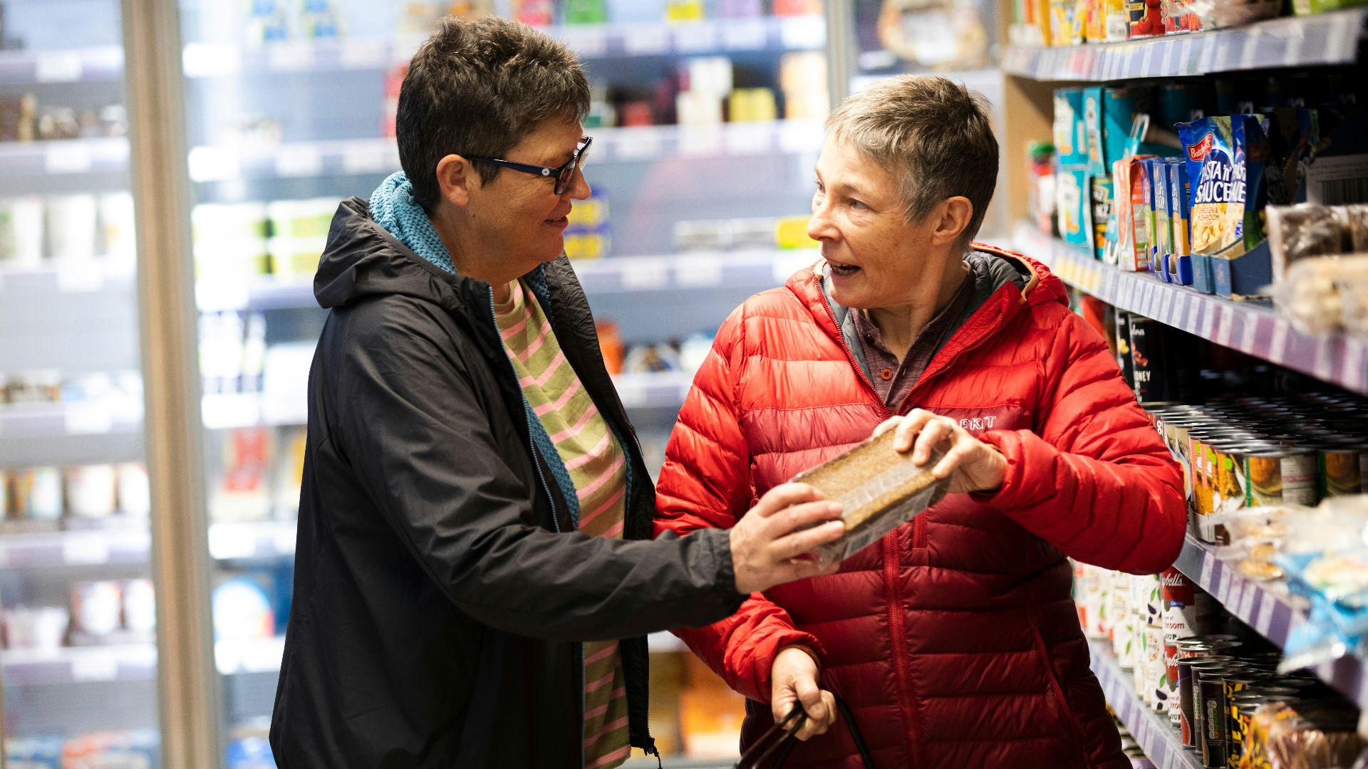 a man and a woman shopping in a grocery store