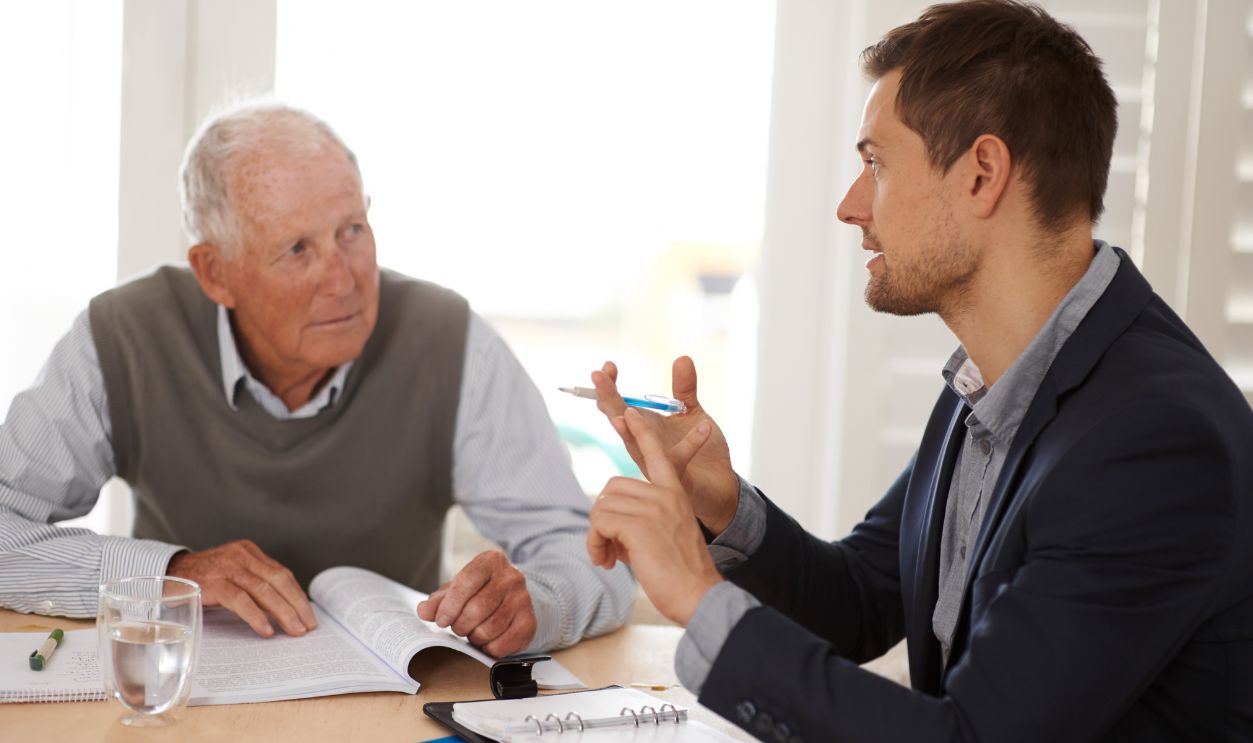 Shutterstock-2298734047, Financial advisor talking to a senior man with an investment, savings or retirement planning. Discussion, documents and professional accountant helping an elderly male person with finance paperwork.