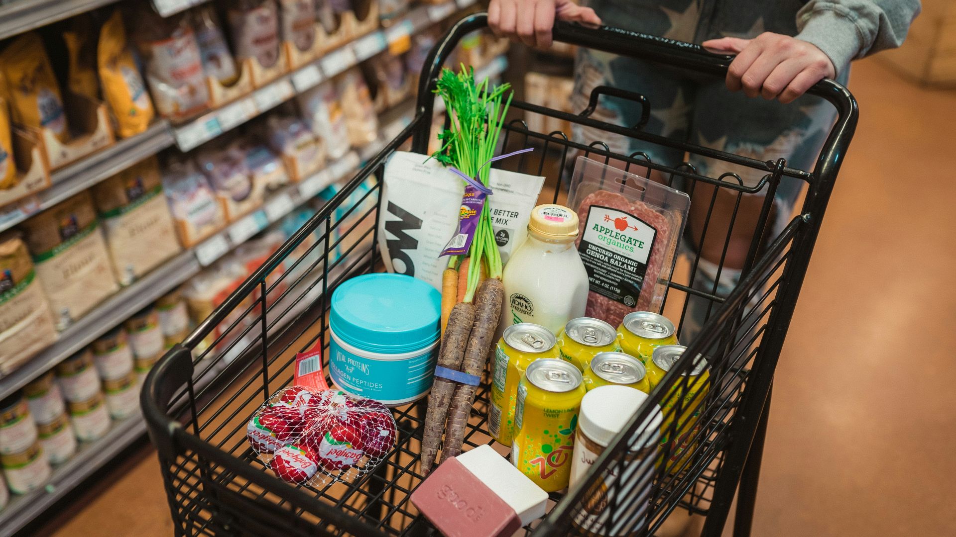 a person pushing a shopping cart full of food