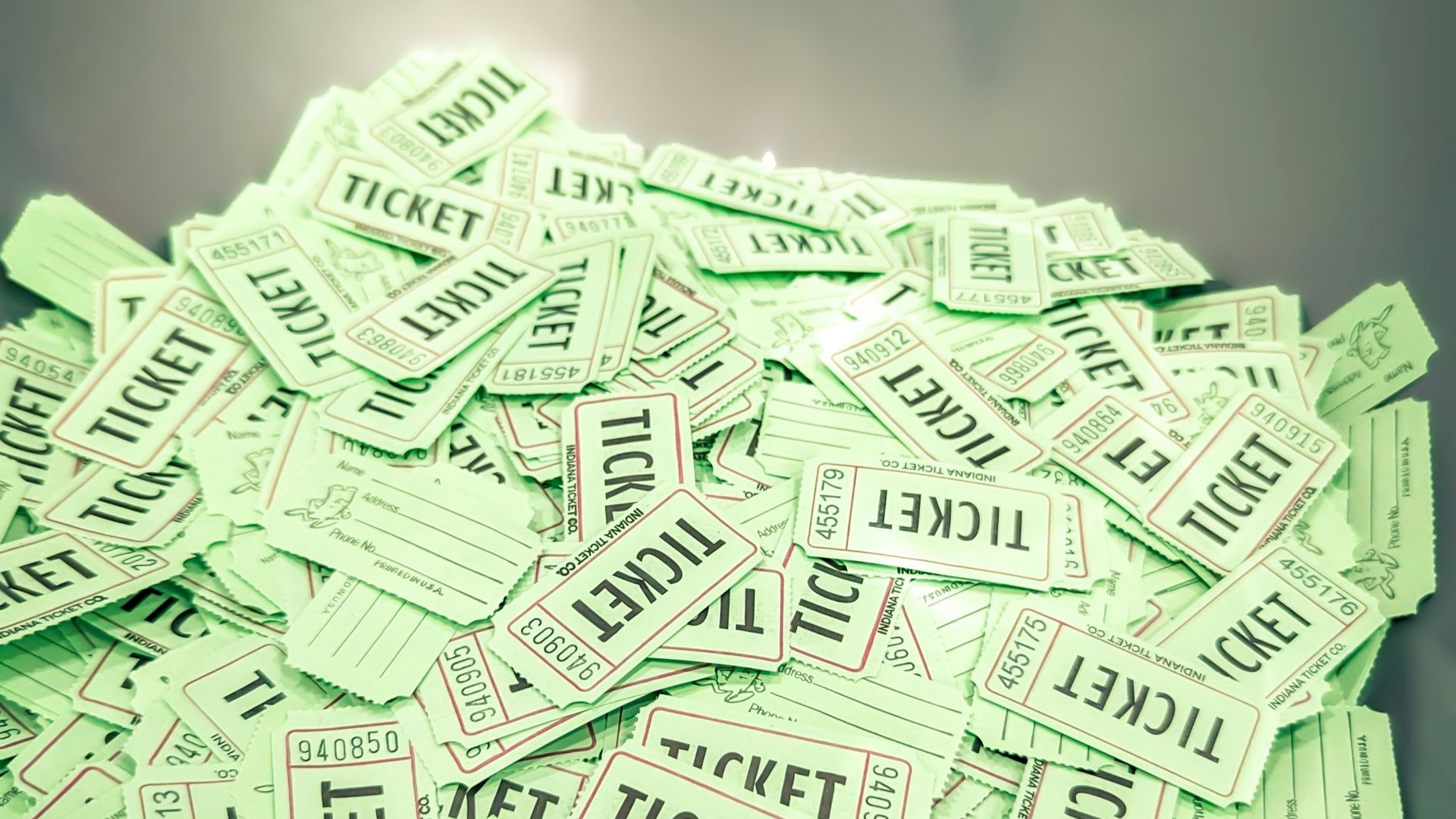 a bowl full of tickets sitting on top of a table