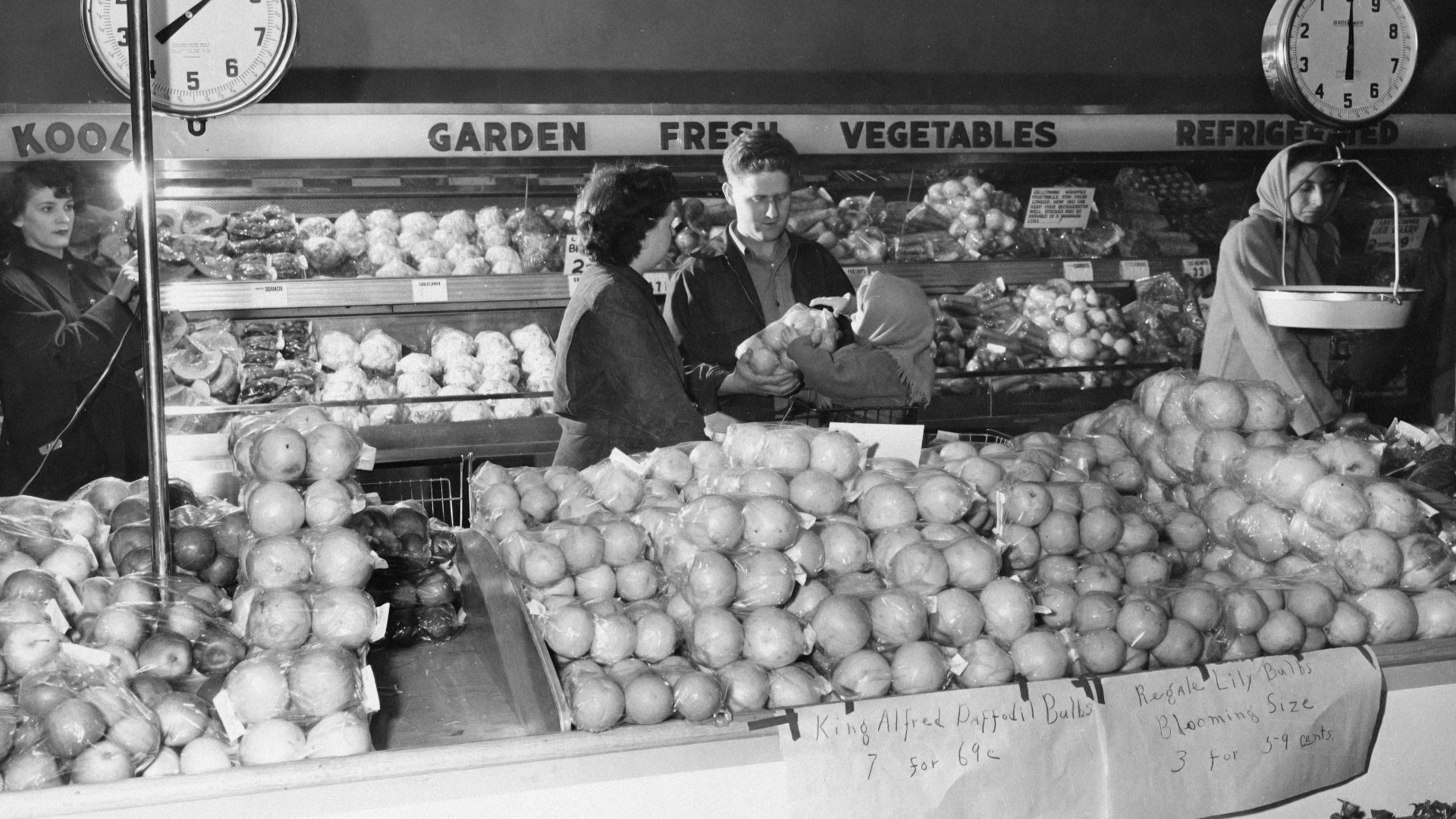 People shopping at a grocery store produce section