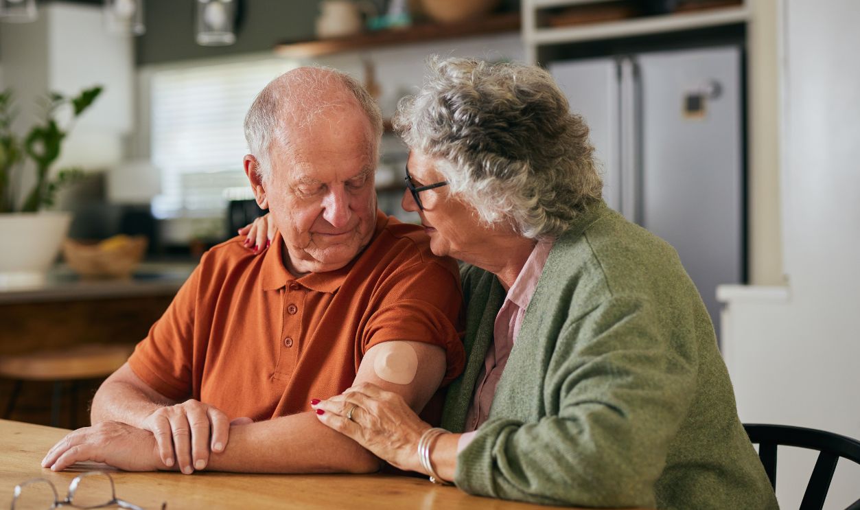 Concerned elderly wife consoling husband during a conversation about blood sugar levels. Supportive older couple sharing an emotional moment while talking about diabetes, taking care concept.