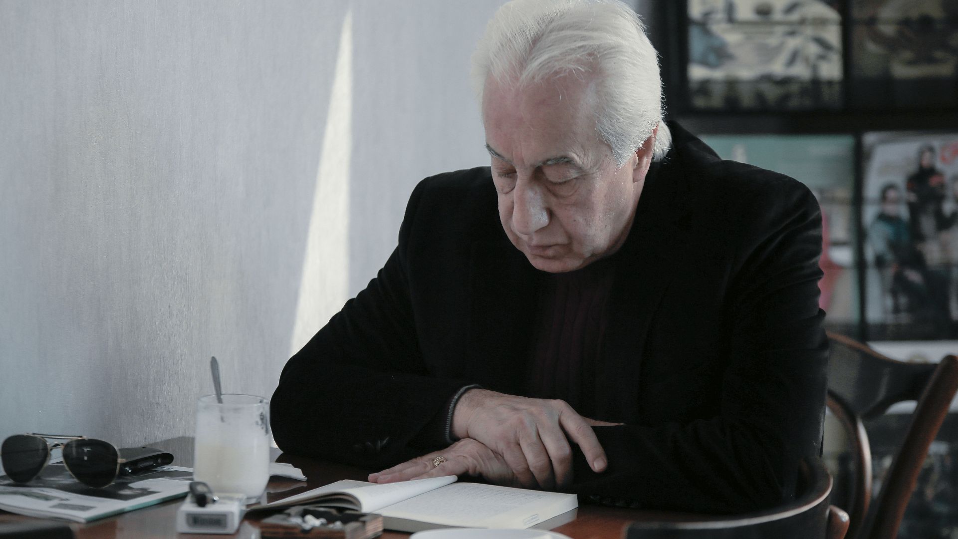 man in black sweater sitting at the table