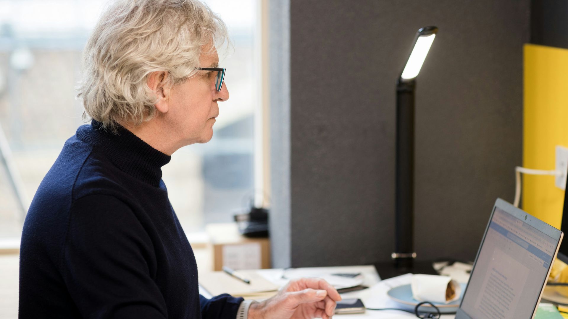 a woman sitting in front of a laptop computer