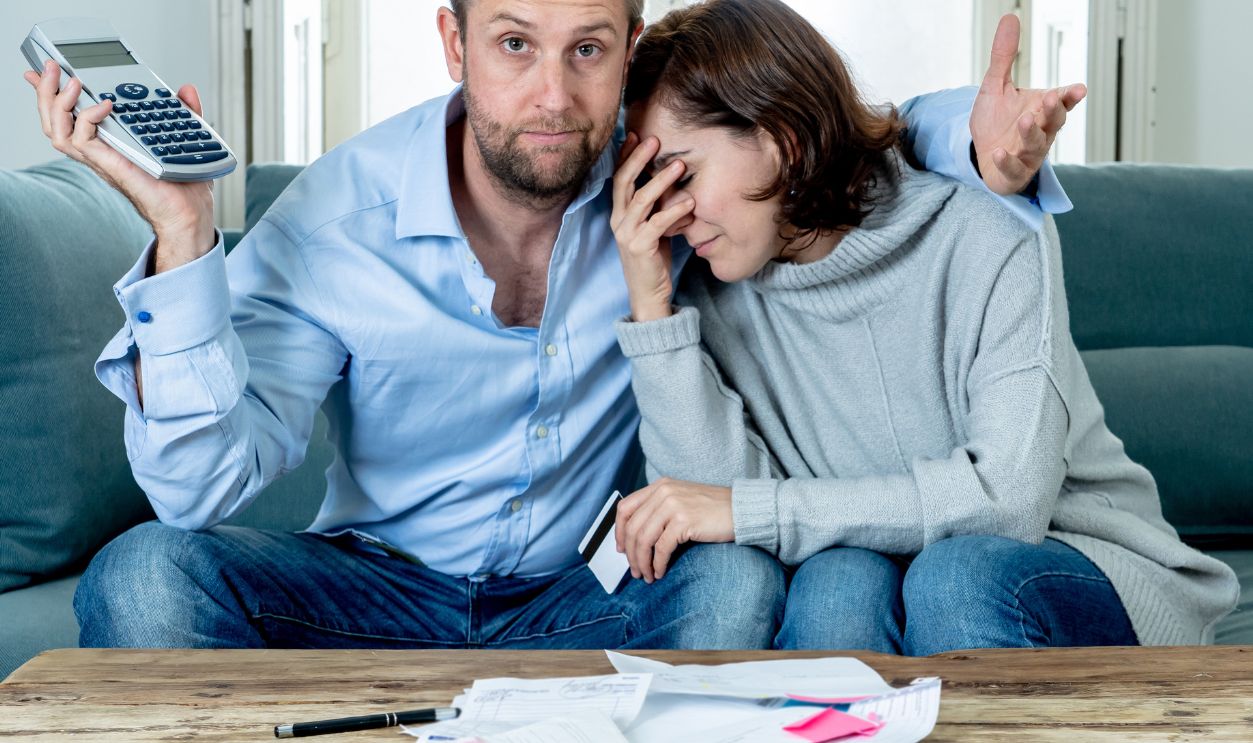 Shutterstock-1422492419, Stressed young couple accounting home finance paying bills mortgage bank statements and expenses feeling desperate having so many debts in bad financial situation and bankruptcy.