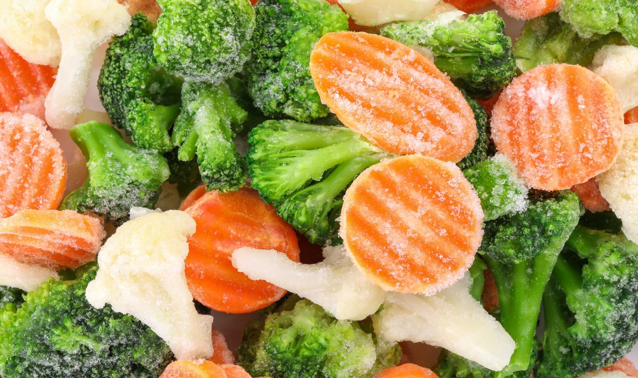Mix of different frozen vegetables as background, top view