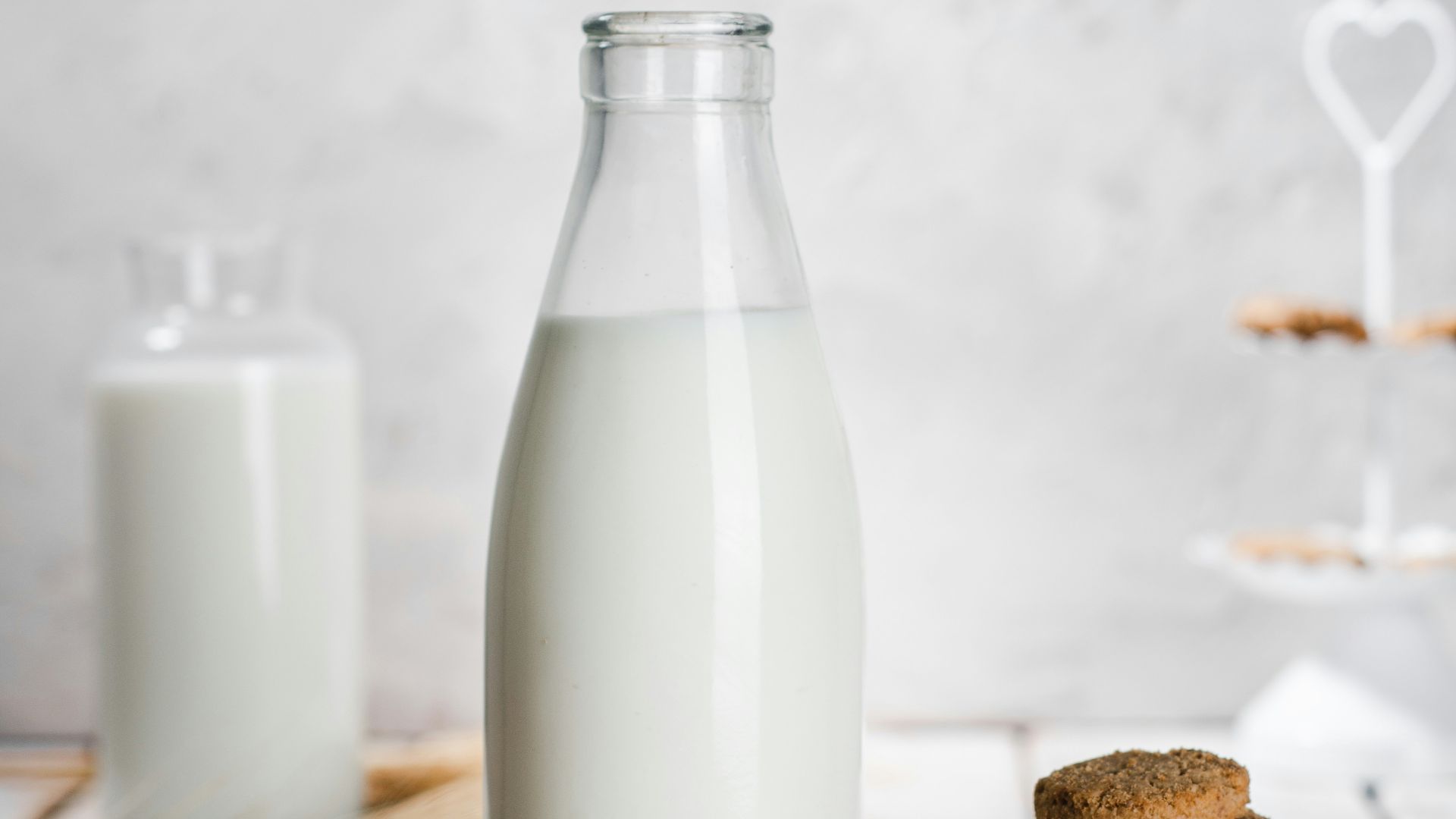 a bottle of milk and some cookies on a table