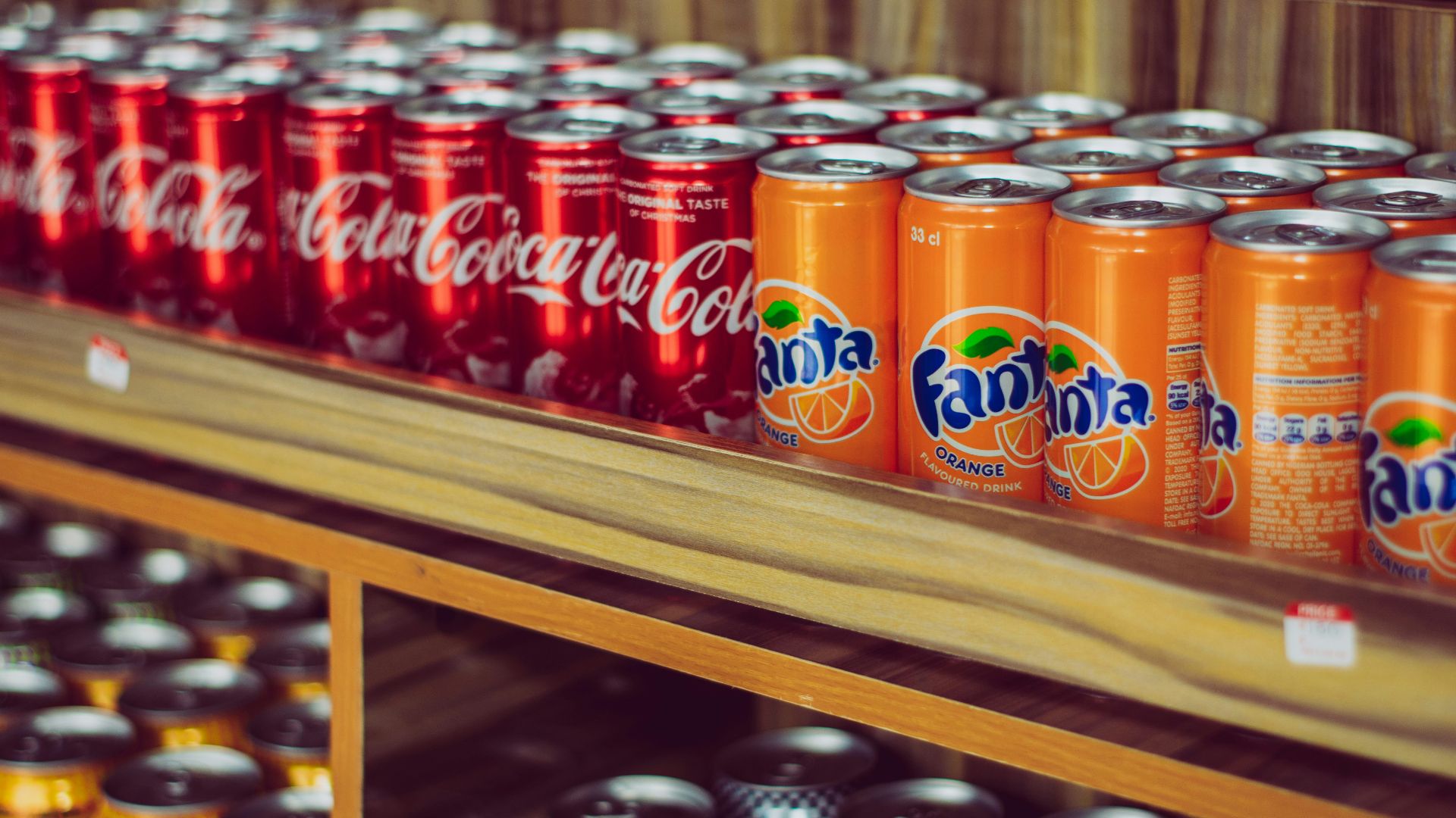 a shelf with cans of soda on it