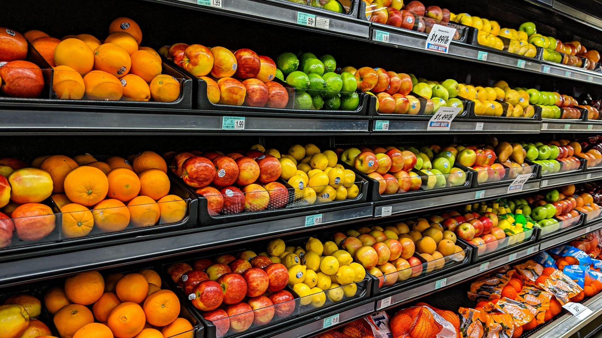 yellow and red apples on black plastic crate