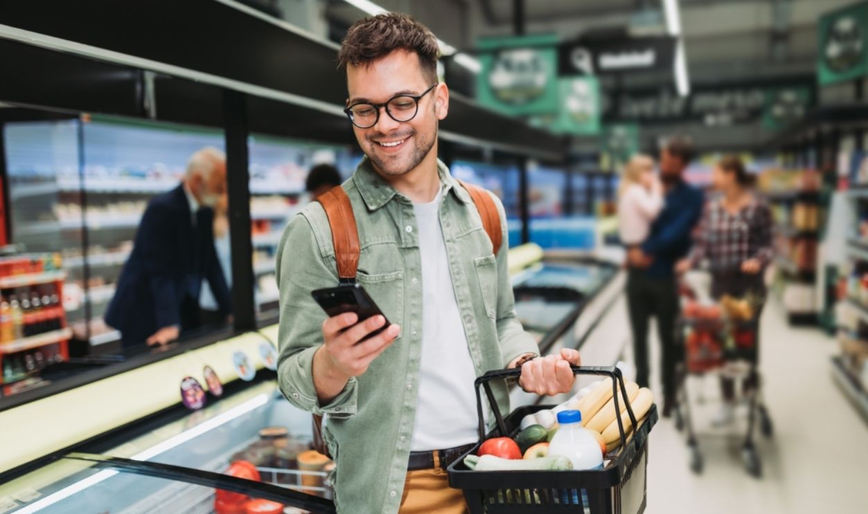 Young man buying groceries at the supermarket