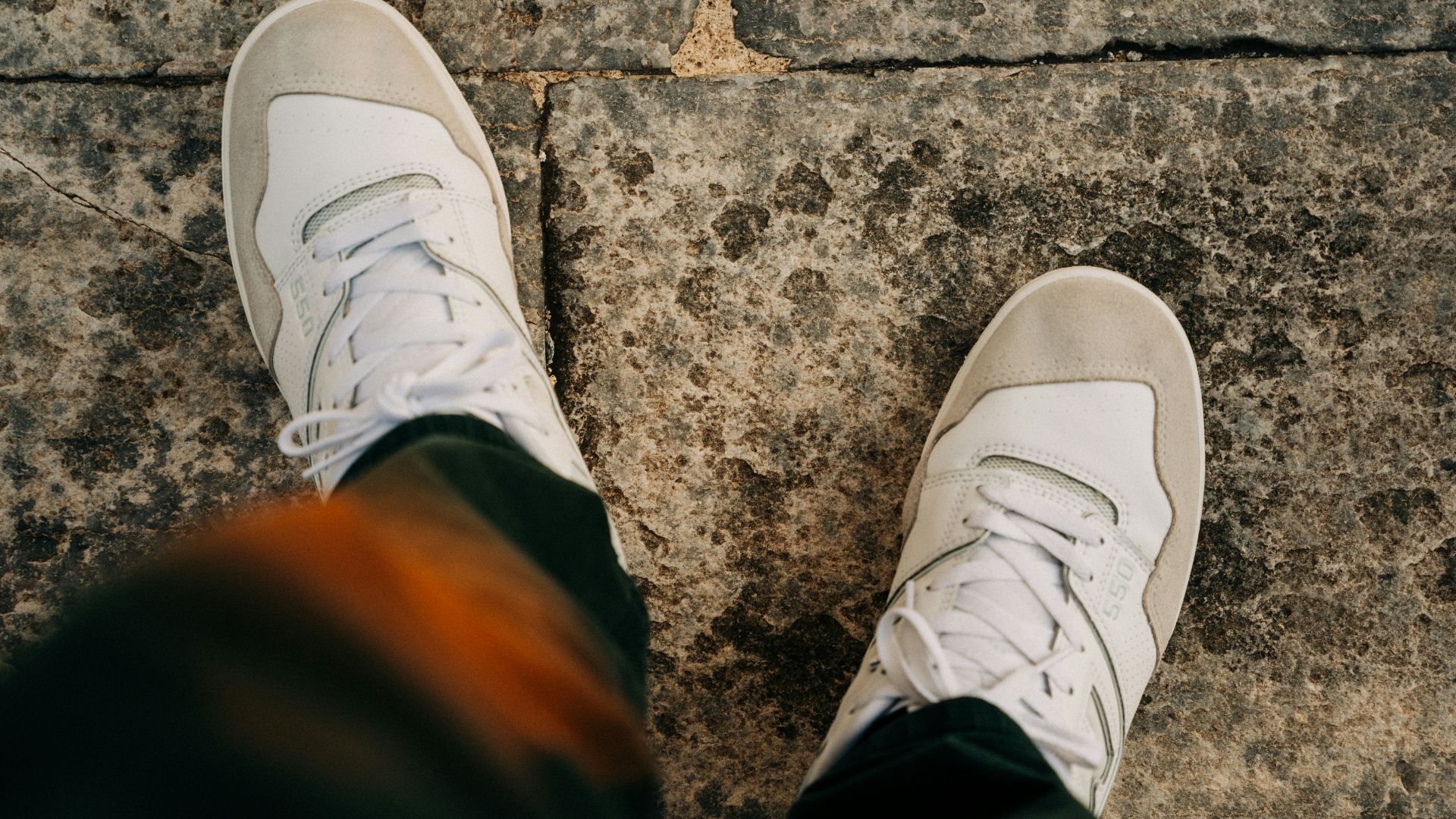a pair of feet with white shoes