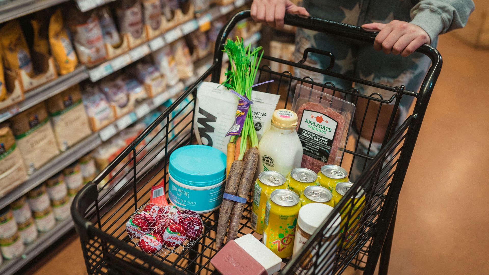 a person pushing a shopping cart full of food