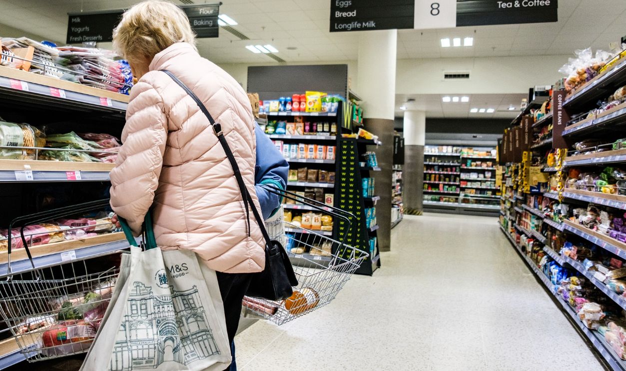 London UK, April 02 2026, Senior Woman Alone Food Shopping, Browsing Bread Products in a UK Supermarket