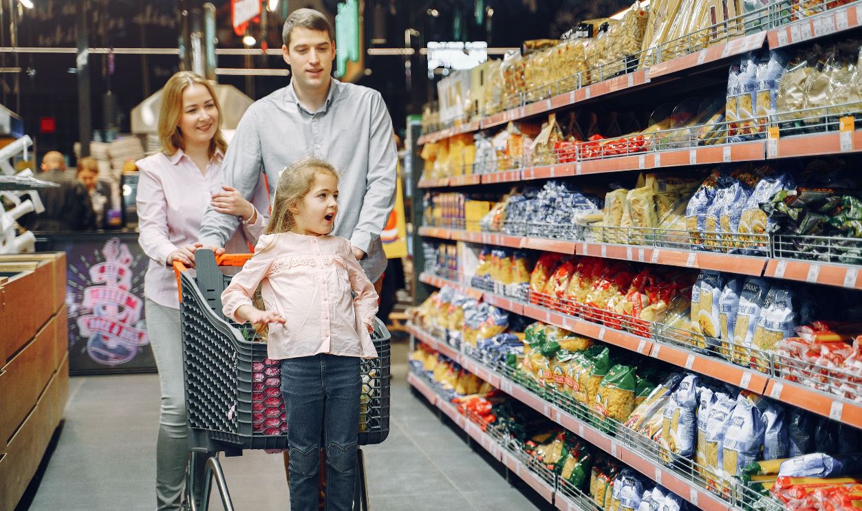 A joyful family enjoying a grocery shopping day together at a supermarket