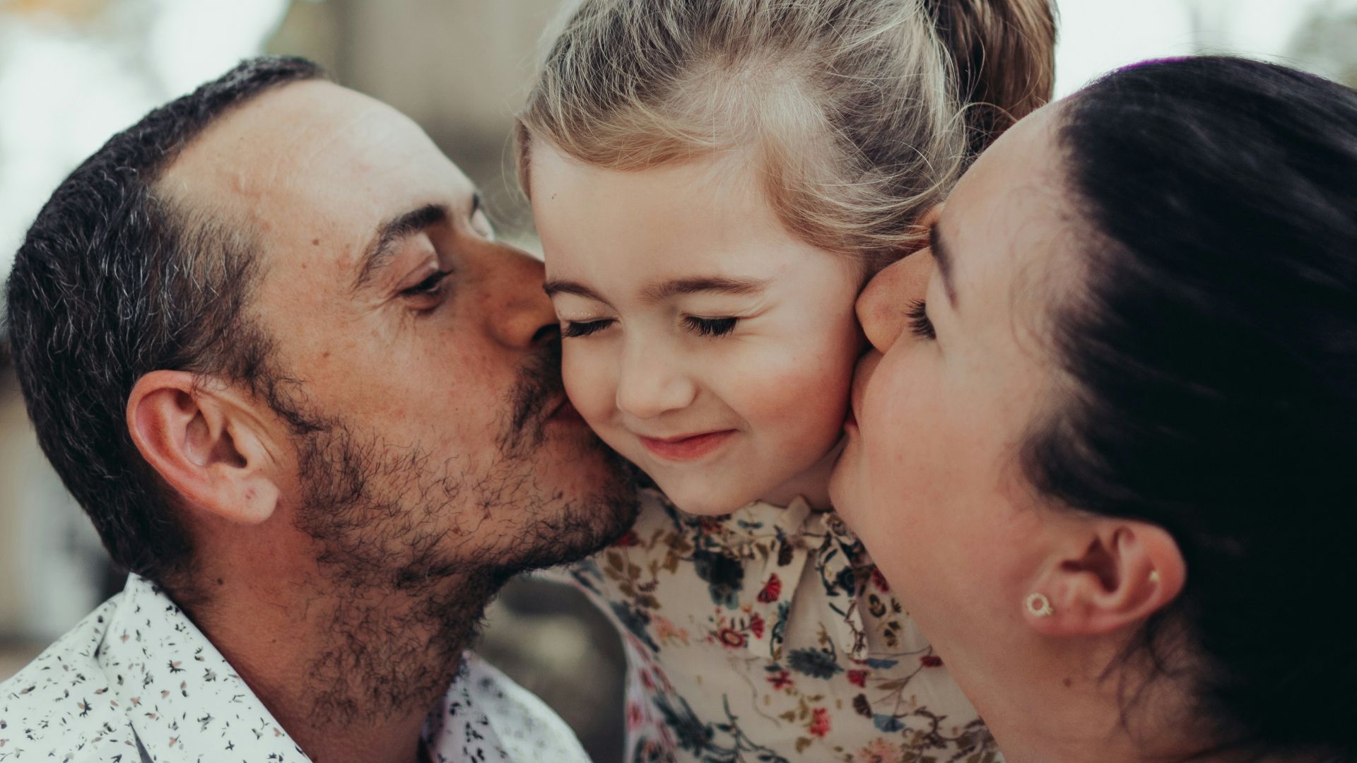 a man kissing a woman on the cheek