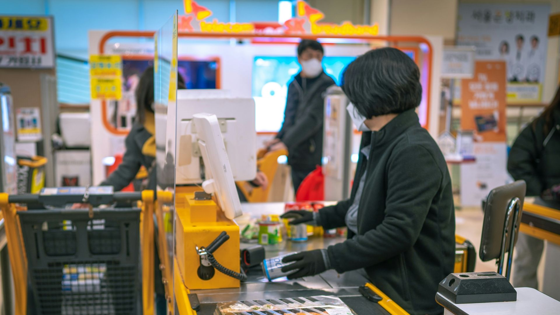 a woman standing at a cash register in a store