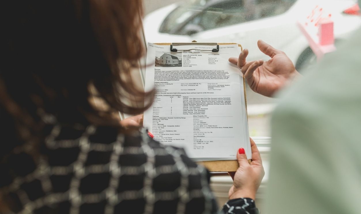 Real estate agent reviewing property documents with a client