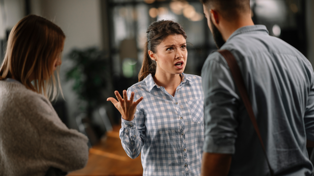 Three people having an argument in office wearing casual clothes