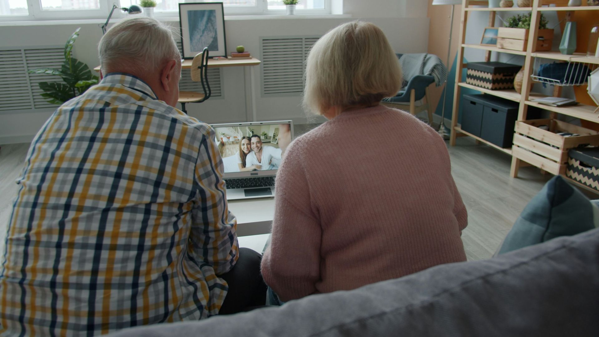 Elderly couple watching a video on laptop at laptop