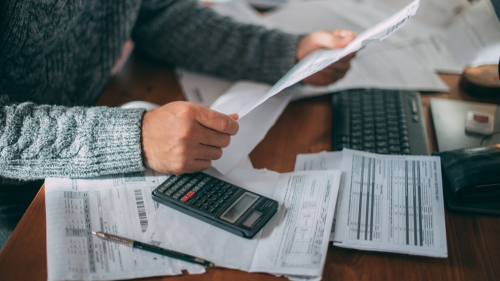 Man calculating and paying his bills