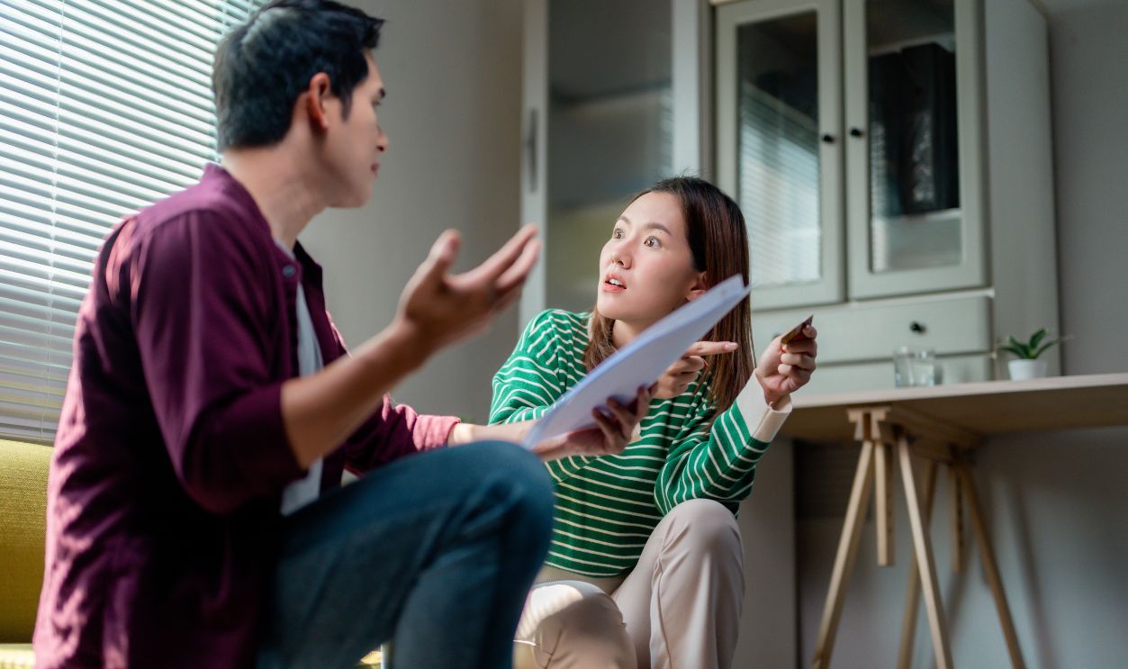Young couple arguing about credit card bills and expenses, having financial problems
