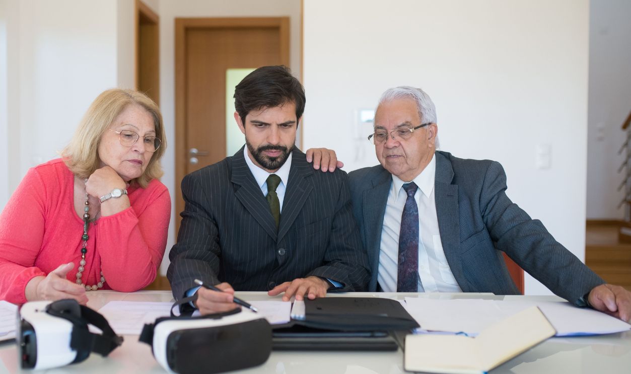 Senior couple in a meeting with a real estate agent discussing property details.