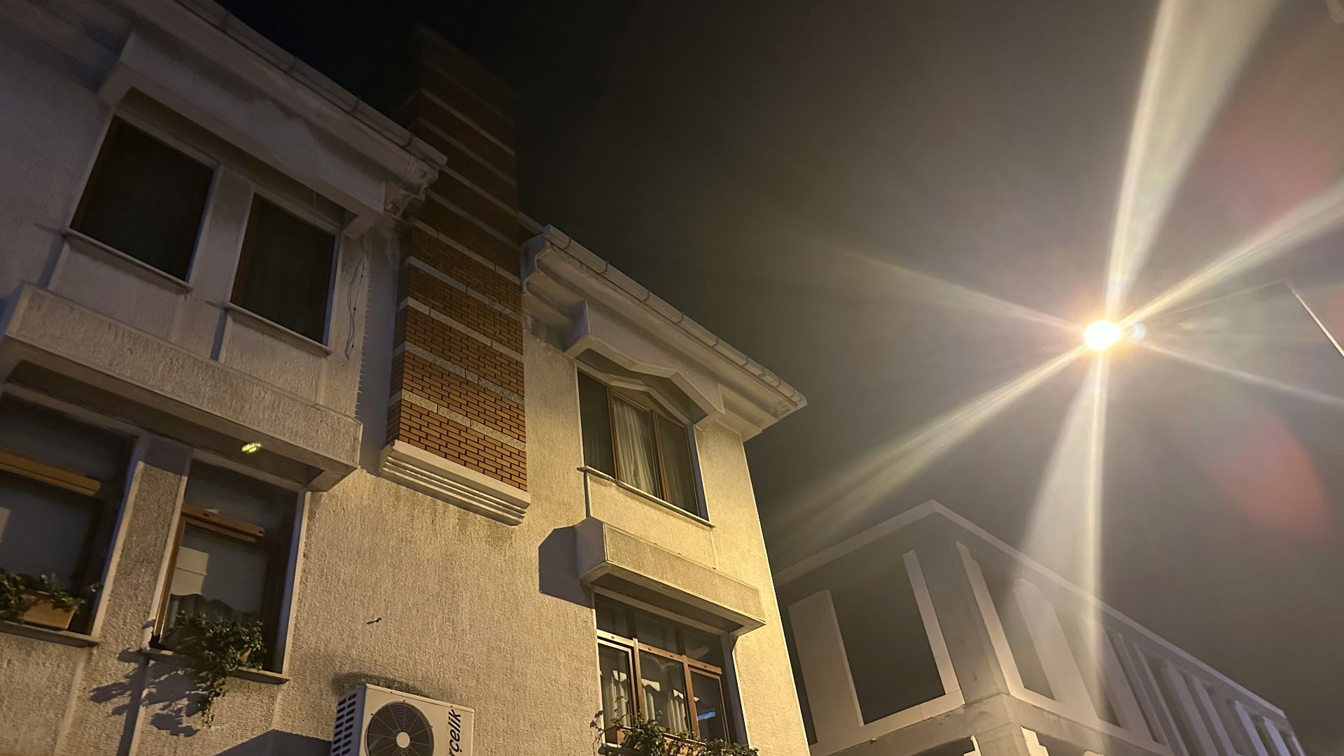 Buildings at night with a bright street light
