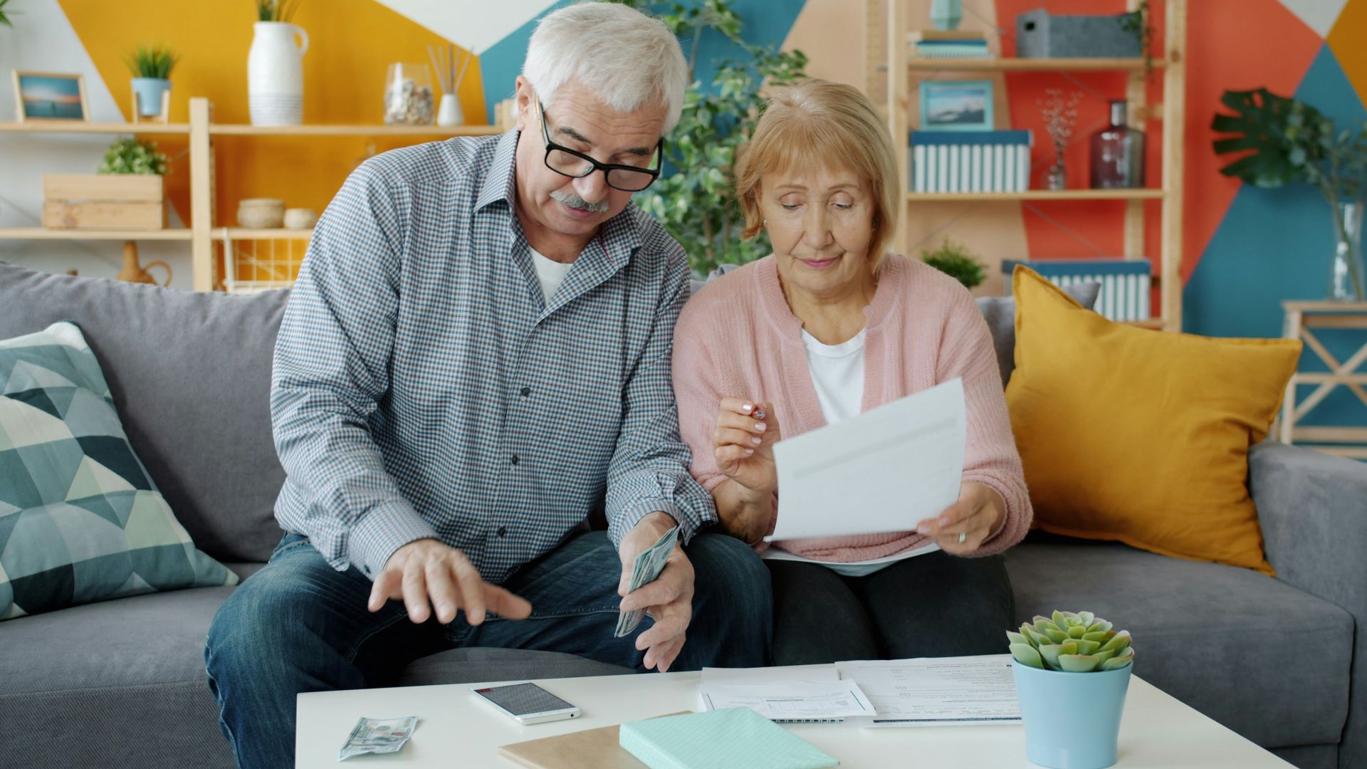 Elderly couple reviewing documents at home