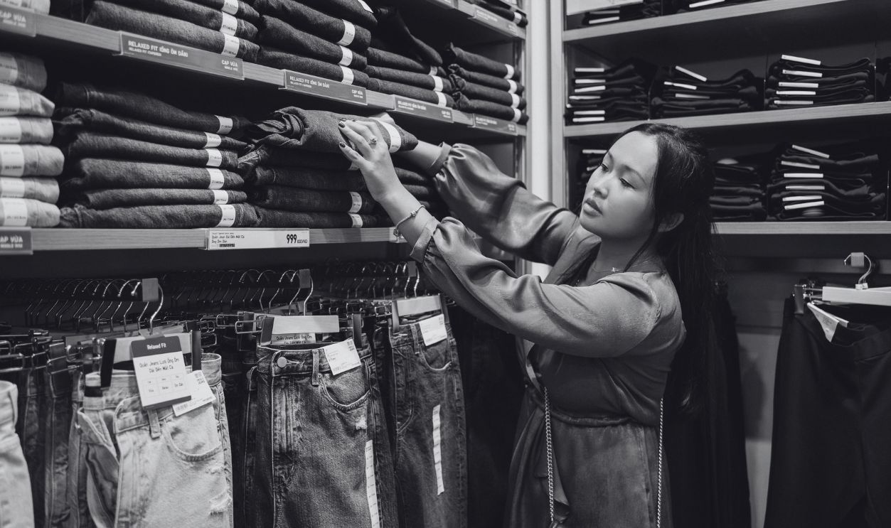 Asian woman browsing denim jeans on shelves