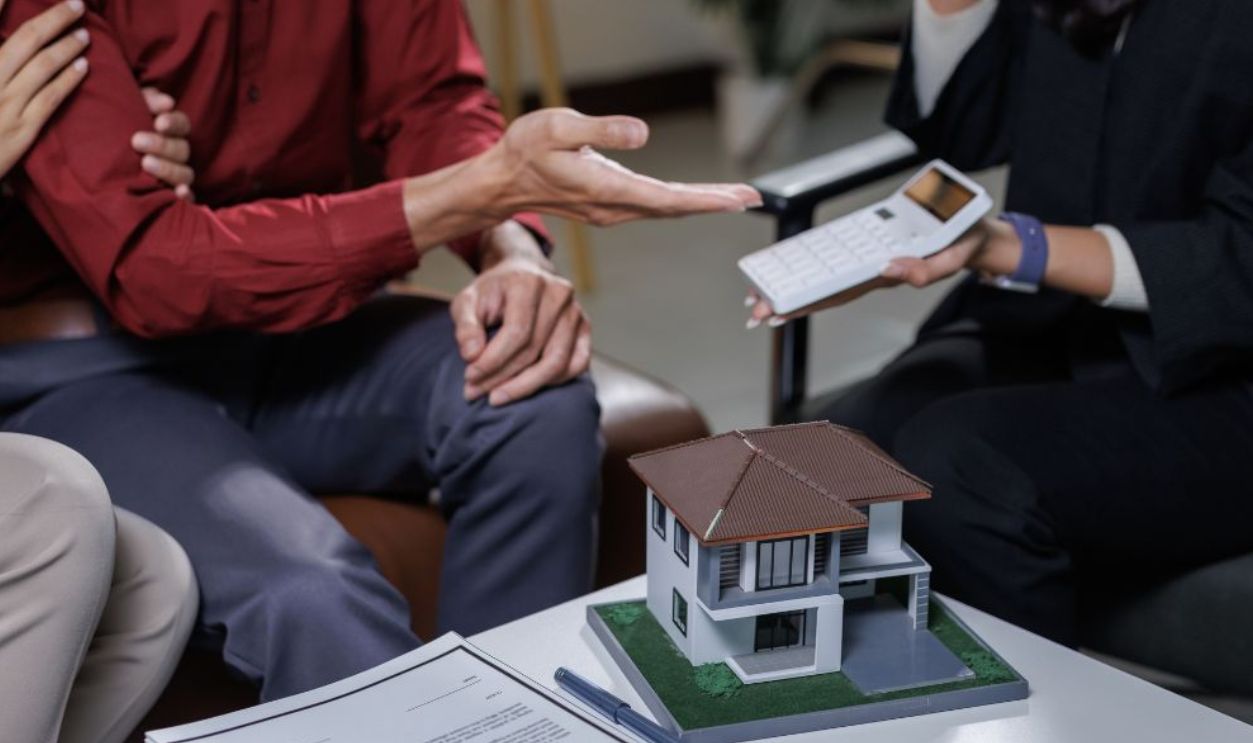Shutterstock-2707122069, Couple having a consultation with a financial advisor about real estate investment and insurance