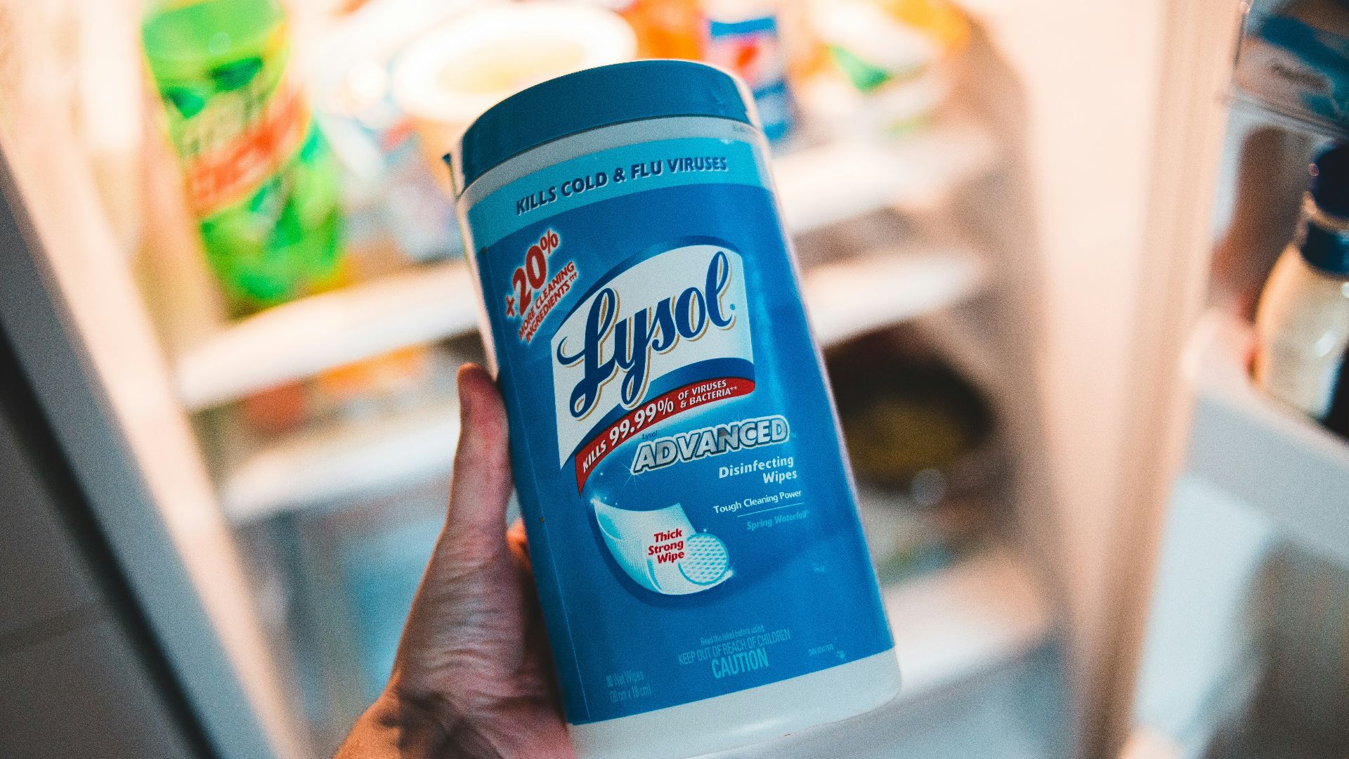 person holding blue and white clorox disinfecting wipes