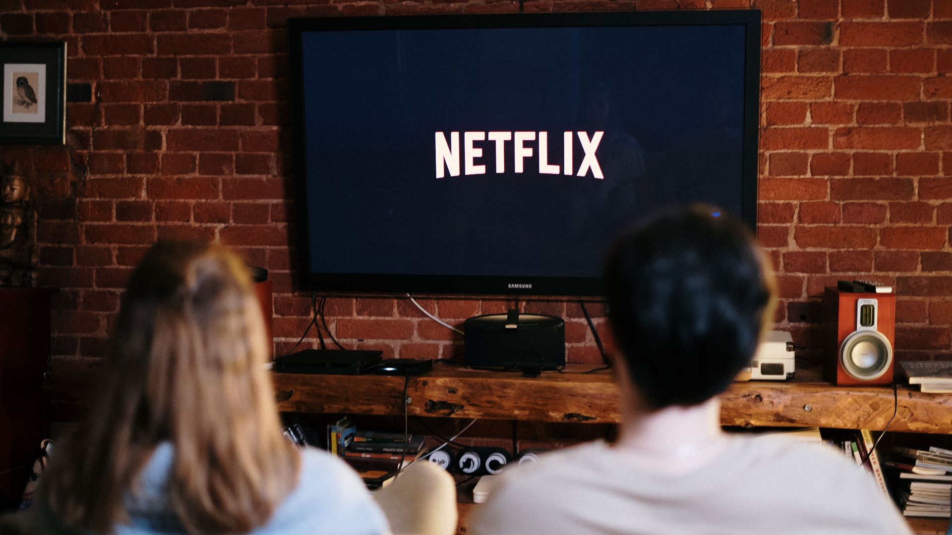 A couple relaxing and watching Netflix in a cozy living room setting.