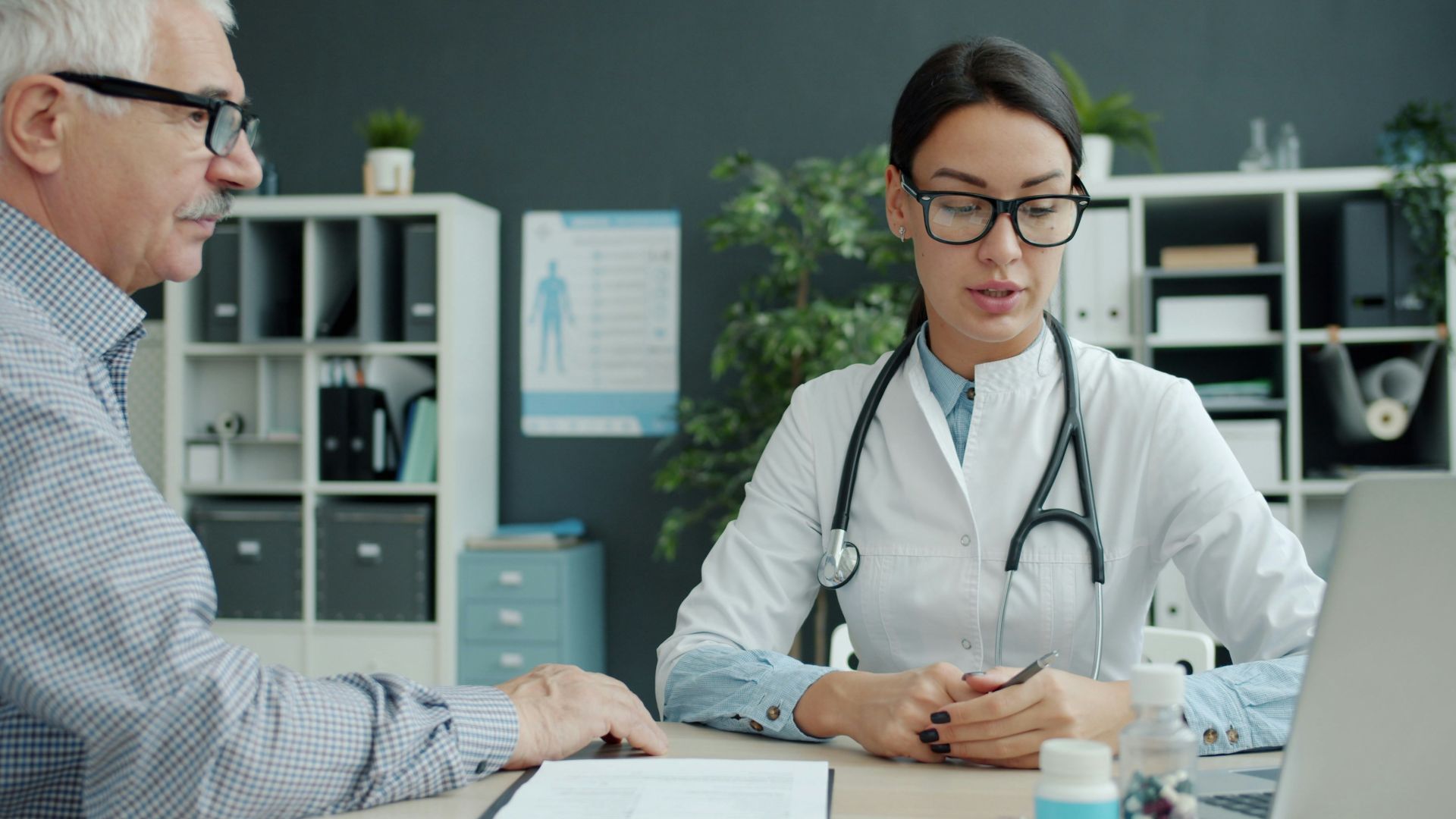 Doctor consulting with an elderly patient in an office