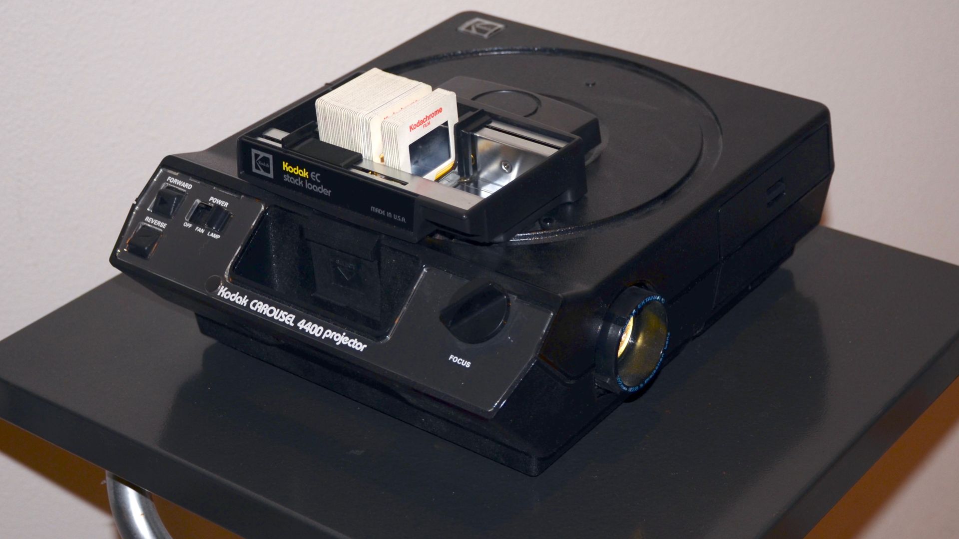 A Kodak Carousel 4400 slide projector with a stack loader in use.